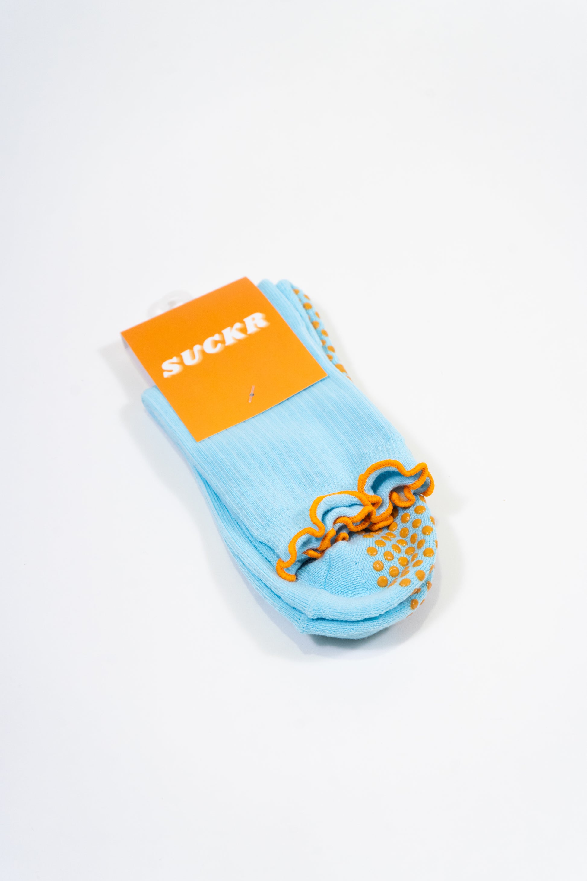 SUCKR  blue frill grip socks, packet photo