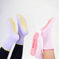 SUCKR princess frill purple and pink gripsocks, feet in the air